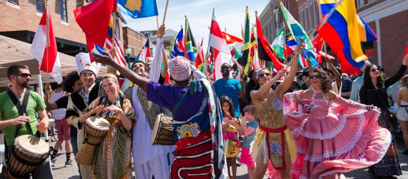 Participants dance and waive the flags of their nations during the annual International Street Fair 2015.