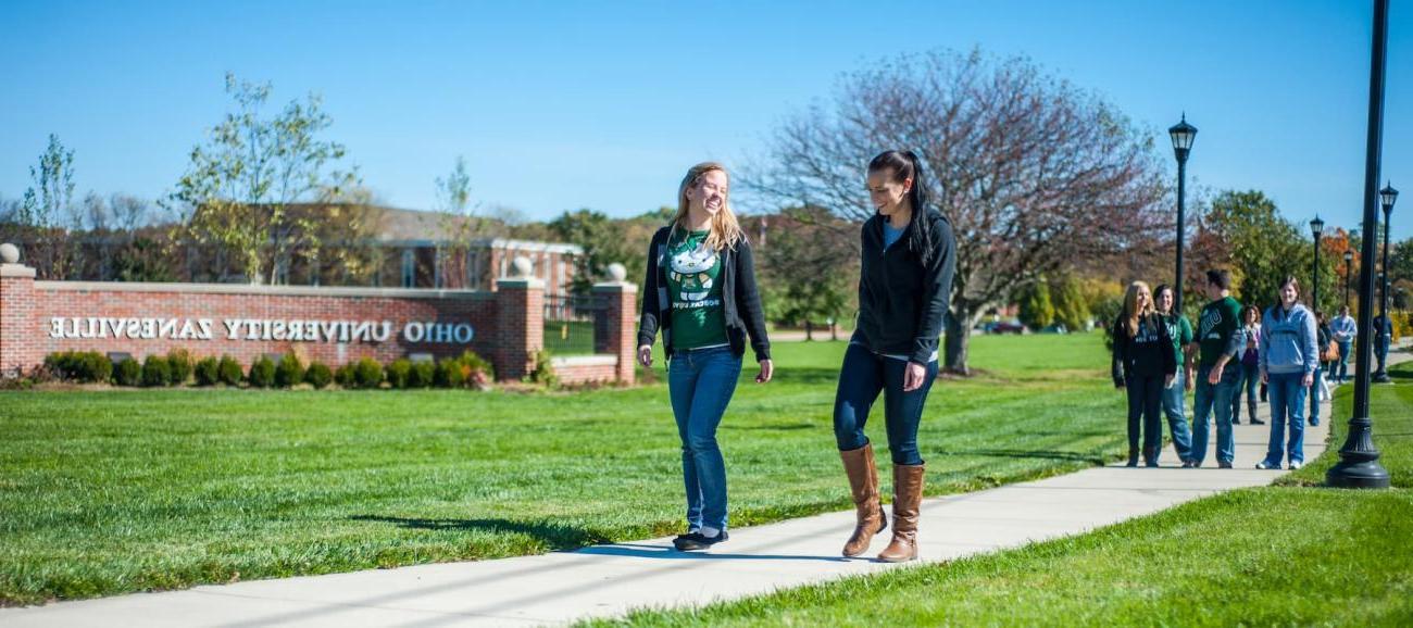 Students walk along a sidewalk at Ohio University's Zanesville campus.